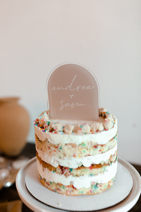  music inspired retro wedding with the bride in a lace gown and the groom in a green suit 