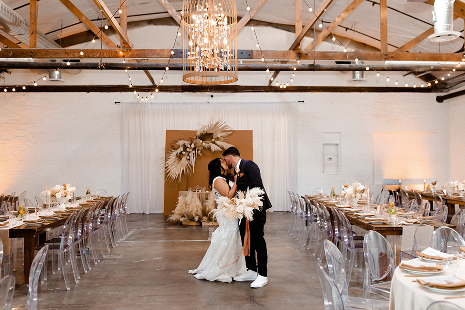  music inspired retro wedding with the bride in a lace gown and the groom in a green suit 