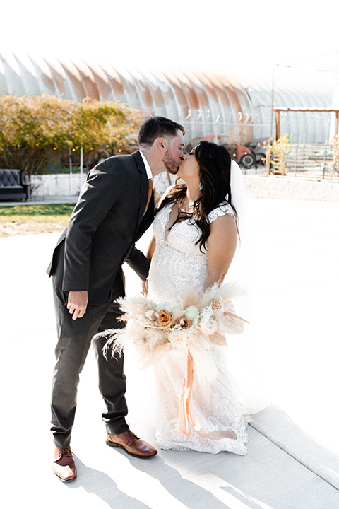  music inspired retro wedding with the bride in a lace gown and the groom in a green suit 