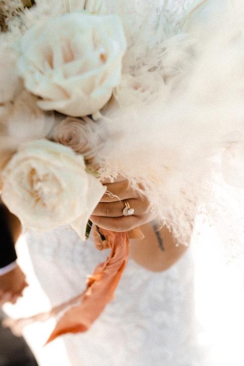  music inspired retro wedding with the bride in a lace gown and the groom in a green suit 