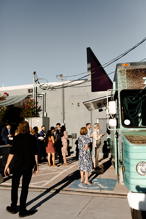  music inspired retro wedding with the bride in a lace gown and the groom in a green suit 