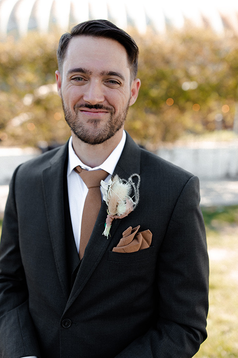  music inspired retro wedding with the bride in a lace gown and the groom in a green suit 