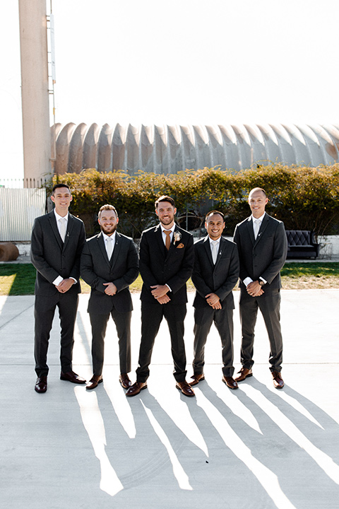  music inspired retro wedding with the bride in a lace gown and the groom in a green suit 