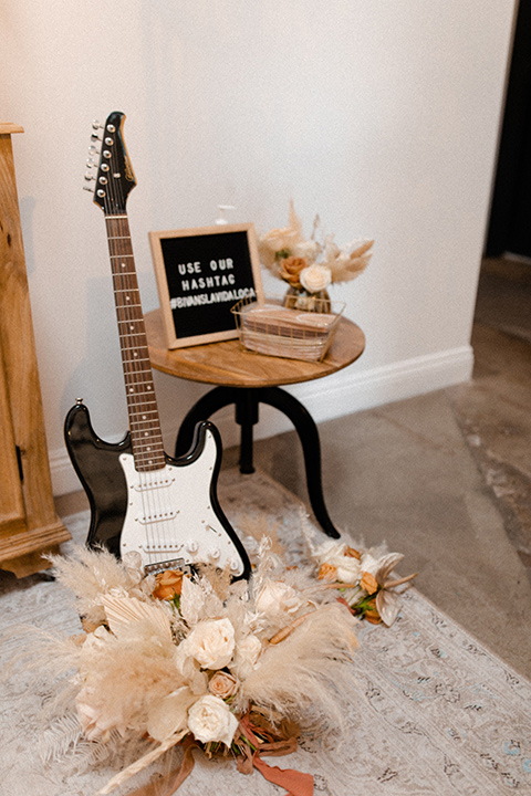  music inspired retro wedding with the bride in a lace gown and the groom in a green suit 