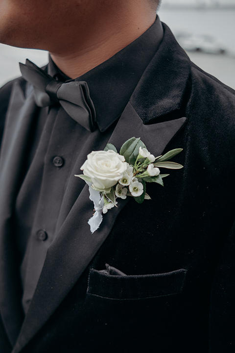  moody dark wedding at with a helicopter venue with the groom in an all-black tuxedo and the bride in a white a-line gown 