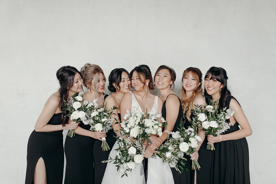  moody dark wedding at with a helicopter venue with the groom in an all-black tuxedo and the bride in a white a-line gown 