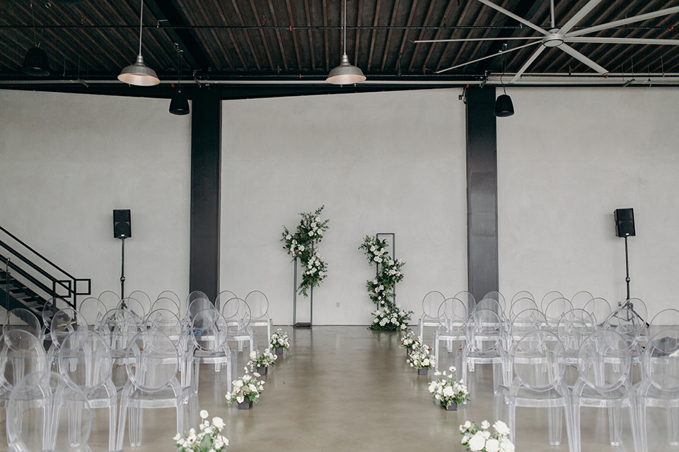 moody dark wedding at with a helicopter venue with the groom in an all-black tuxedo and the bride in a white a-line gown 