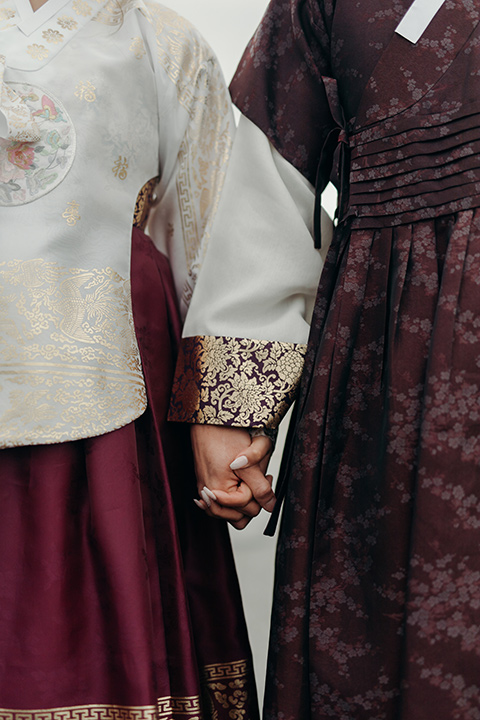  moody dark wedding at with a helicopter venue with the groom in an all-black tuxedo and the bride in a white a-line gown 