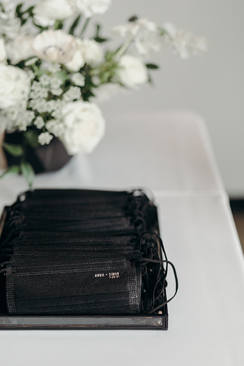  moody dark wedding at with a helicopter venue with the groom in an all-black tuxedo and the bride in a white a-line gown 