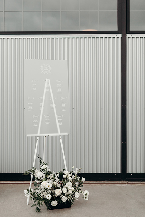  moody dark wedding at with a helicopter venue with the groom in an all-black tuxedo and the bride in a white a-line gown 