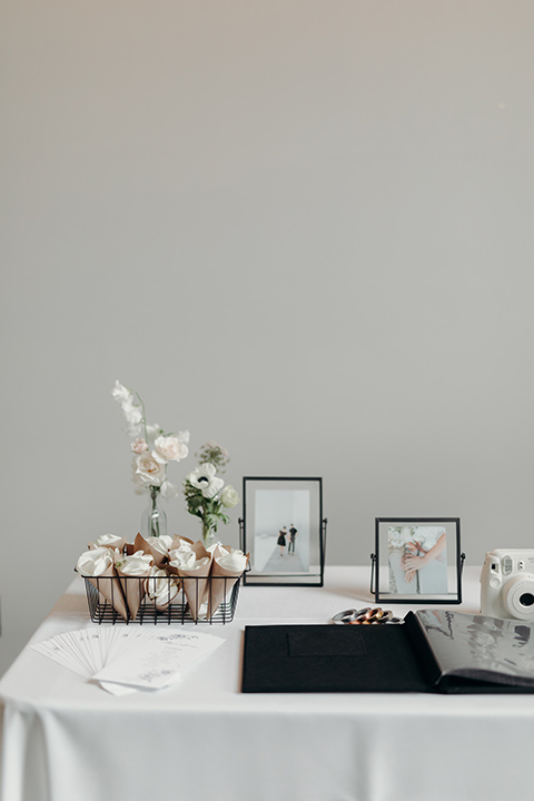  moody dark wedding at with a helicopter venue with the groom in an all-black tuxedo and the bride in a white a-line gown 