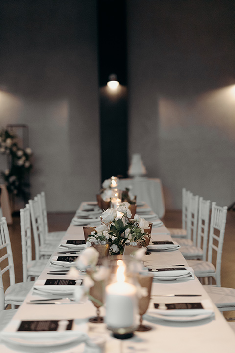  moody dark wedding at with a helicopter venue with the groom in an all-black tuxedo and the bride in a white a-line gown 