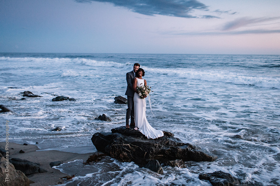  rustic boho wedding with warm colors and the bride in an off the shoulder gown and the groom in a caramel suit 