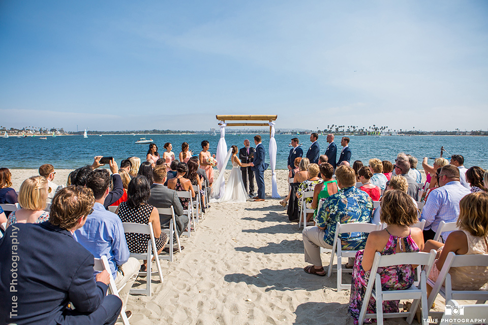  rustic boho wedding with warm colors and the bride in an off the shoulder gown and the groom in a caramel suit 