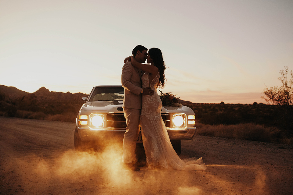  boho adventure elopement in Joshua tree, CA – by the car at sunset 