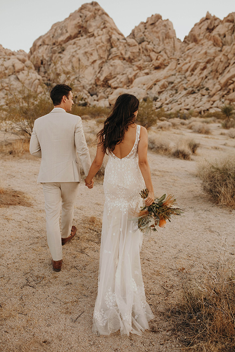  boho adventure elopement in Joshua tree, CA – couple walking in the desert 