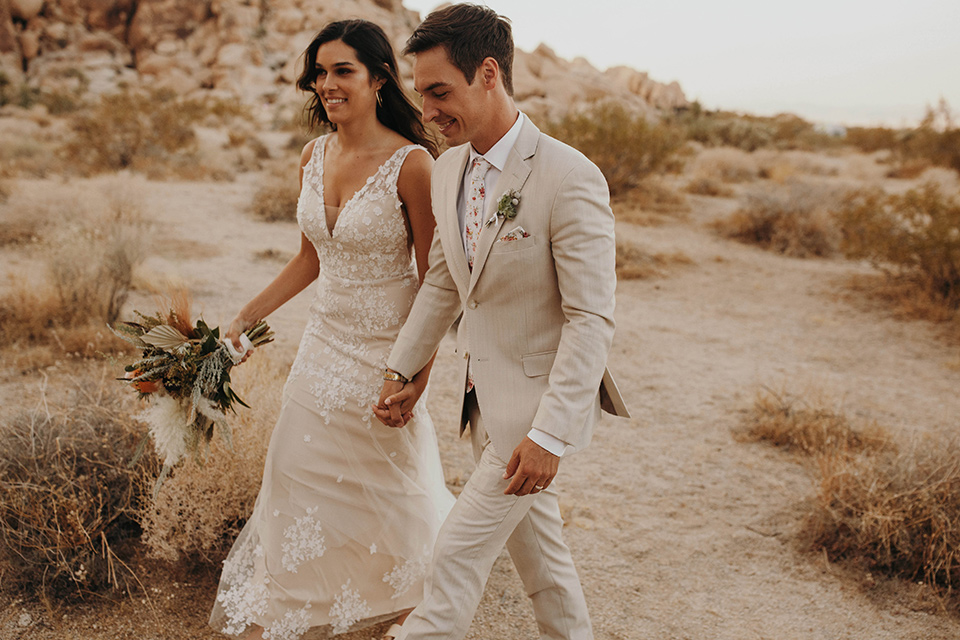  boho adventure elopement in Joshua tree, CA – walking holding hands