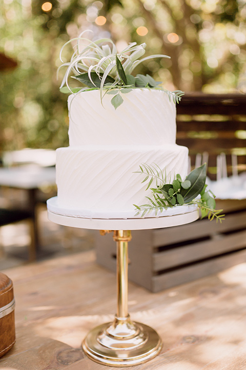  bohemian wedding with the bride in a flowing lace gown and the groom in a caramel brown suit with a green velvet bow tie- dessert