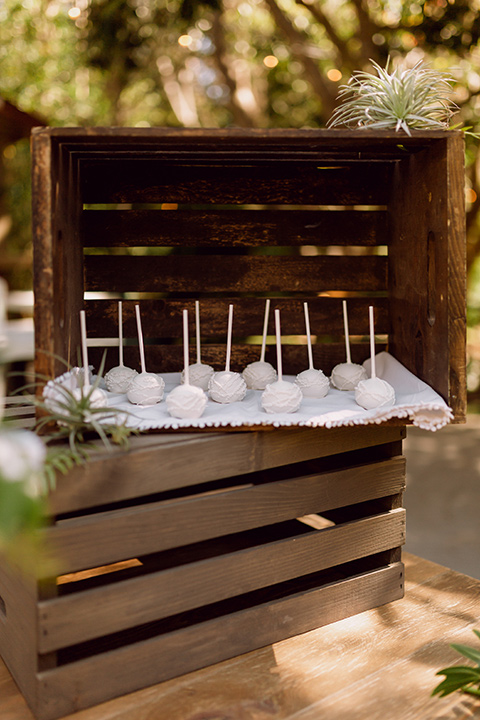  bohemian wedding with the bride in a flowing lace gown and the groom in a caramel brown suit with a green velvet bow tie- dessert 