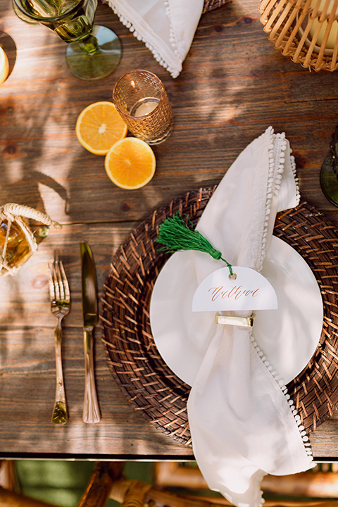  bohemian wedding with the bride in a flowing lace gown and the groom in a caramel brown suit with a green velvet bow tie- flatware 
