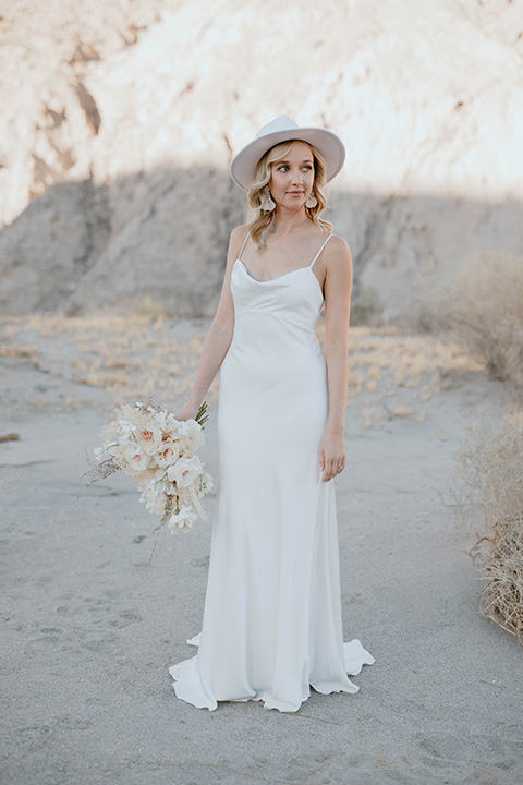  boho wedding in the desert with the groom in a black suit and the bride in a boho bridal gown 