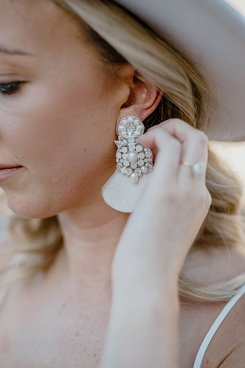  boho wedding in the desert with the groom in a black suit and the bride in a boho bridal gown 