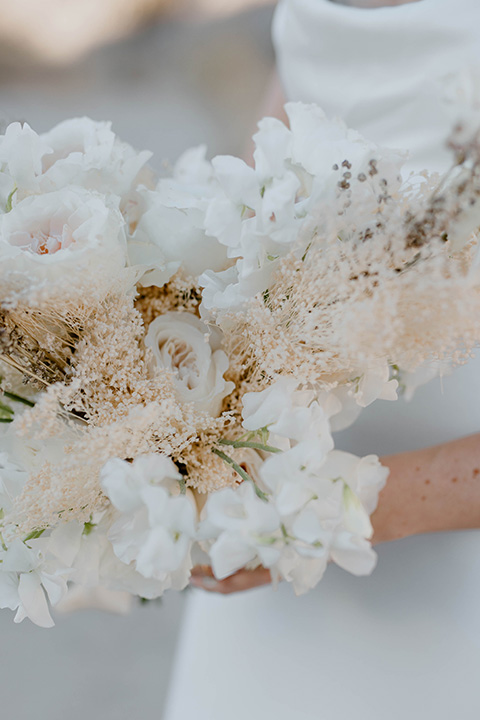  boho wedding in the desert with the groom in a black suit and the bride in a boho bridal gown 