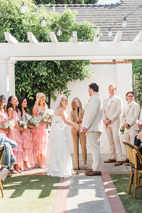  tan and pink garden wedding with floral bridesmaid dresses and the groom and groomsmen in tan suits – ceremony 