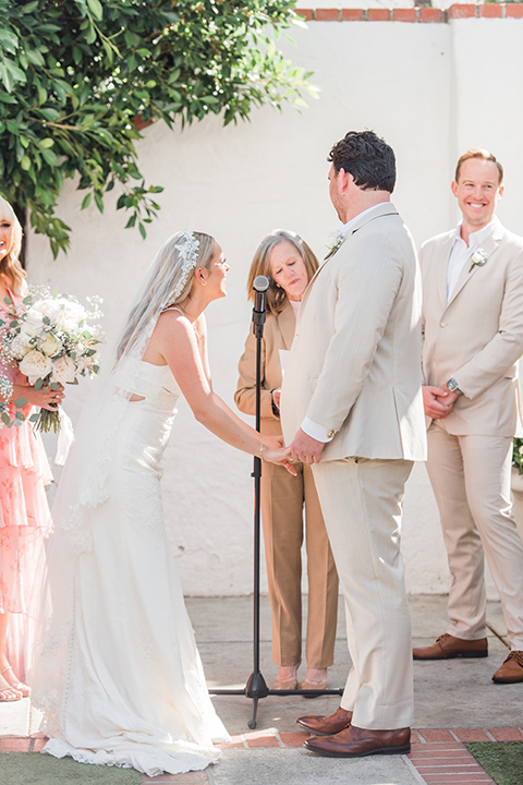  tan and pink garden wedding with floral bridesmaid dresses and the groom and groomsmen in tan suits – ceremony 