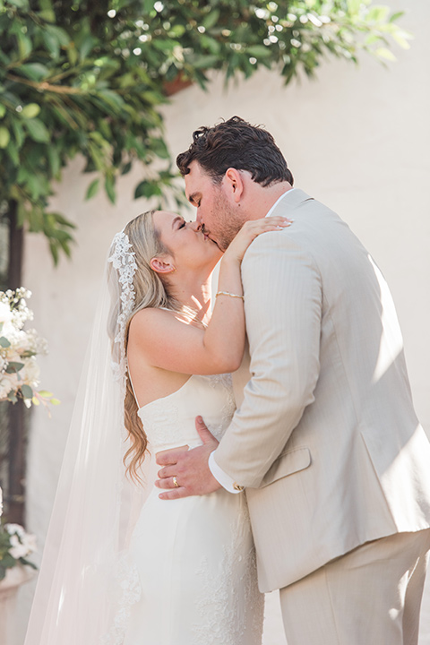  tan and pink garden wedding with floral bridesmaid dresses and the groom and groomsmen in tan suits – ceremony 