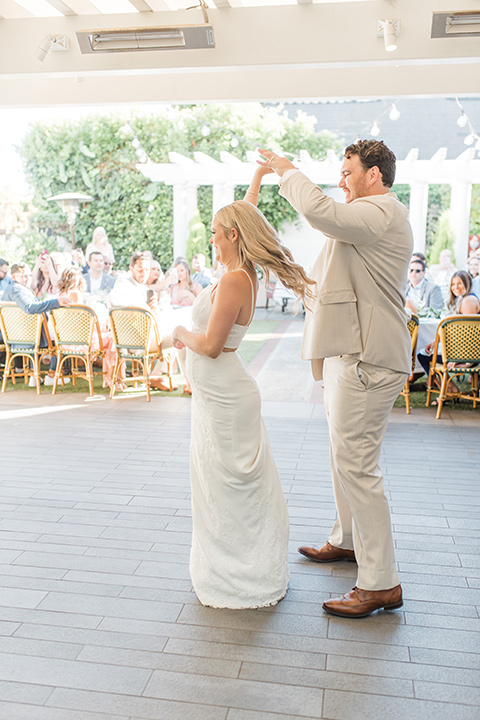  tan and pink garden wedding with floral bridesmaid dresses and the groom and groomsmen in tan suits – first dance 