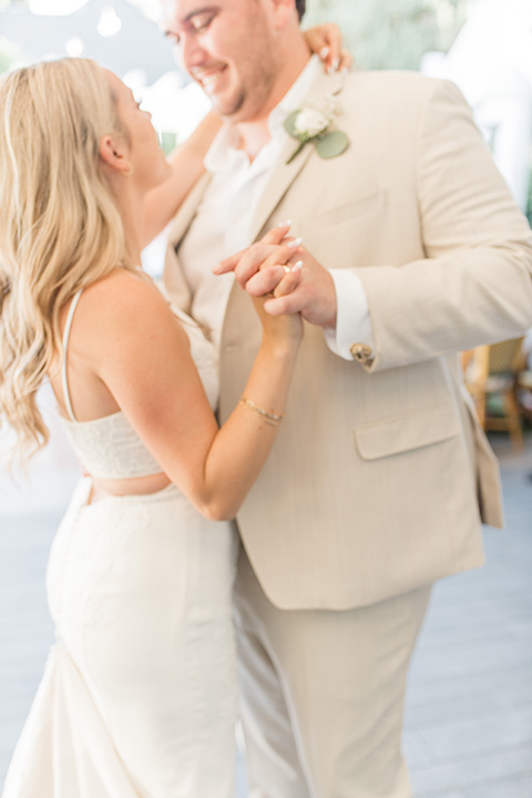  tan and pink garden wedding with floral bridesmaid dresses and the groom and groomsmen in tan suits – first dance 