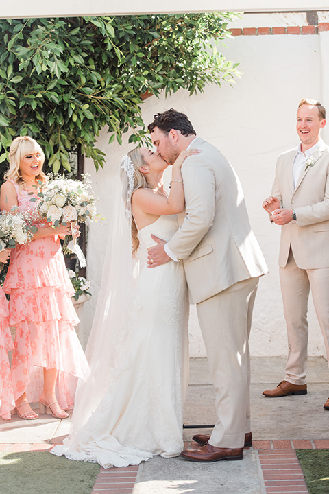  tan and pink garden wedding with floral bridesmaid dresses and the groom and groomsmen in tan suits – ceremony 