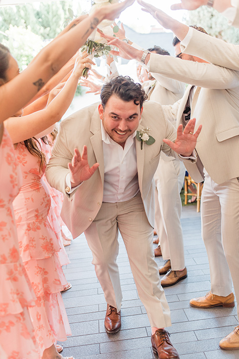  tan and pink garden wedding with floral bridesmaid dresses and the groom and groomsmen in tan suits – tunnel 