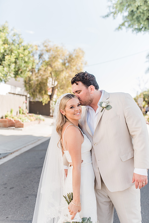  tan and pink garden wedding with floral bridesmaid dresses and the groom and groomsmen in tan suits – smiling 