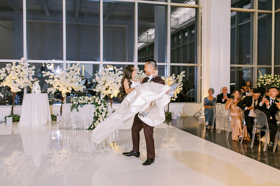 A city wedding with the guys in burgundy and black tuxedos and the bridesmaids in blush dresses- first dance