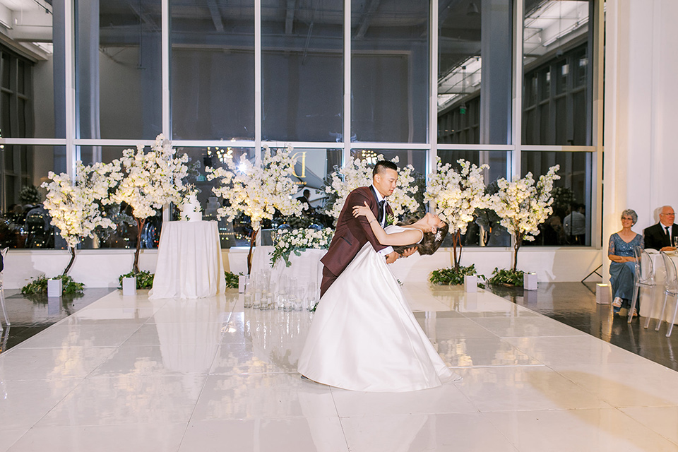 A city wedding with the guys in burgundy and black tuxedos and the bridesmaids in blush dresses- first dance