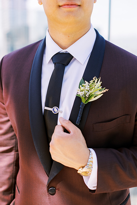  A city wedding with the guys in burgundy and black tuxedos and the bridesmaids in blush dresses- groom in a burgundy tuxedo