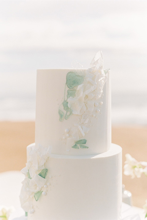  luxe black and white wedding on the beach in san diego – bride in a light blue gown and the groom in a white and black shawl tuxedo