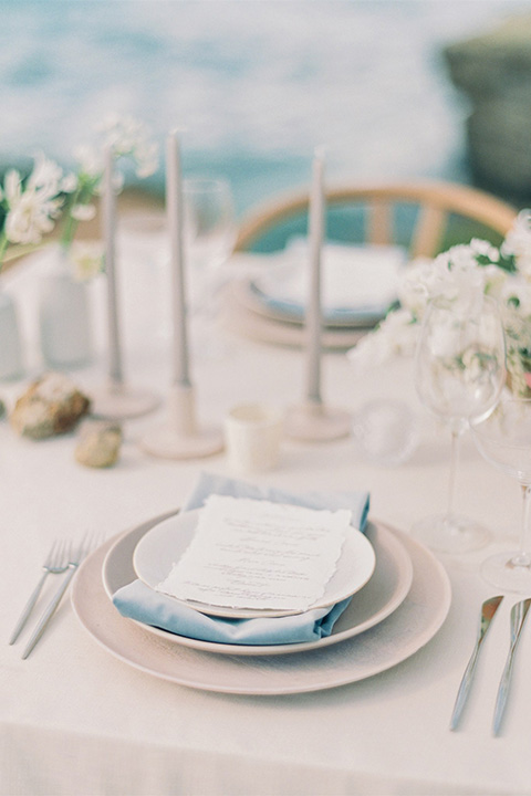  luxe black and white wedding on the beach in san diego – bride in a light blue gown and the groom in a white and black shawl tuxedo 