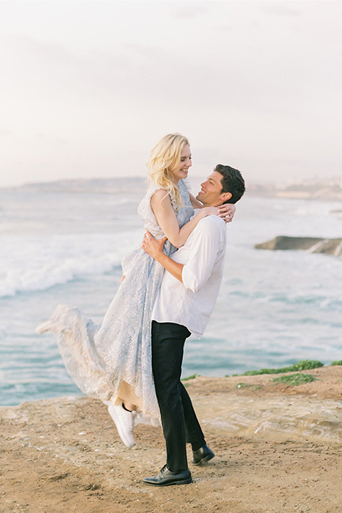  luxe black and white wedding on the beach in san diego – bride in a light blue gown and the groom in a white and black shawl tuxedo