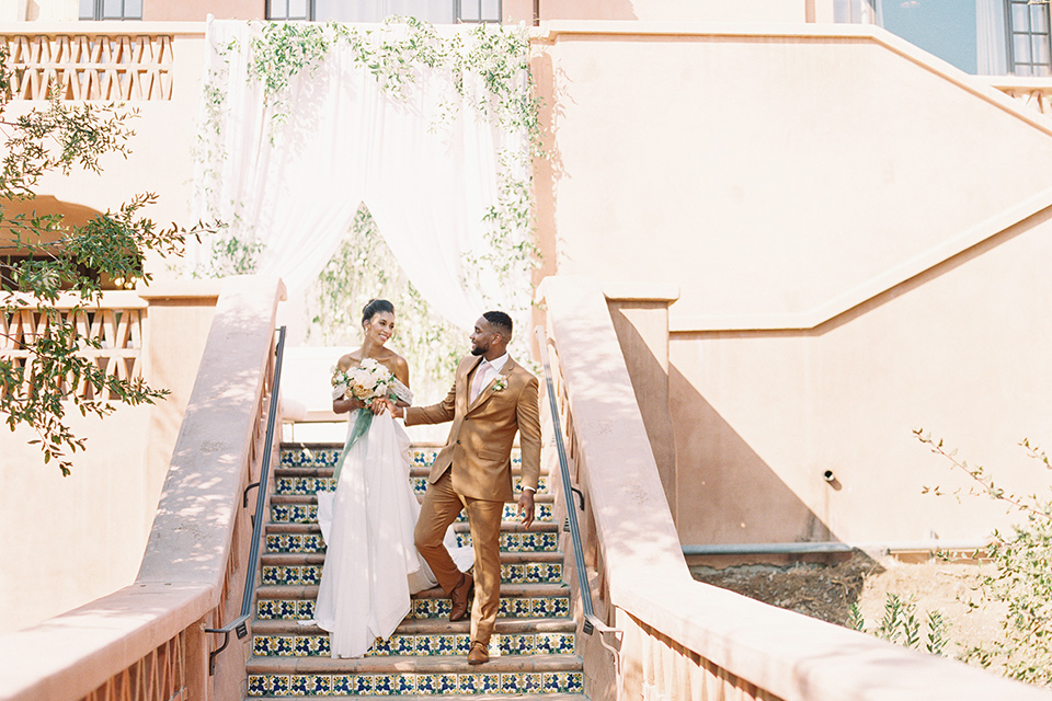  blush and ivory wedding with the groom in a caramel brown suit and the bride in a lace gown