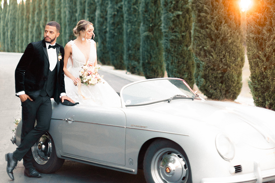  caramel mountain wedding with  black tie flare and the groom in a black velvet tuxedo – couple on car