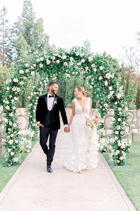  caramel mountain wedding with  black tie flare and the groom in a black velvet tuxedo – walking down the aisle 