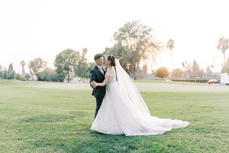  navy and white garden wedding with the groom in a navy suit and the bride in a white ballgown – couple 
