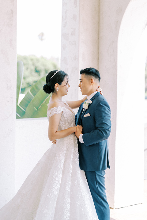  navy and white garden wedding with the groom in a navy suit and the bride in a white ballgown – couple