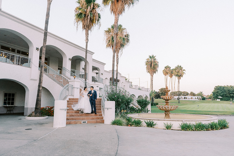  navy and white garden wedding with the groom in a navy suit and the bride in a white ballgown – couple 