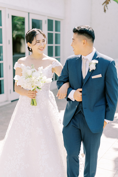  navy and white garden wedding with the groom in a navy suit and the bride in a white ballgown – newlyweds 
