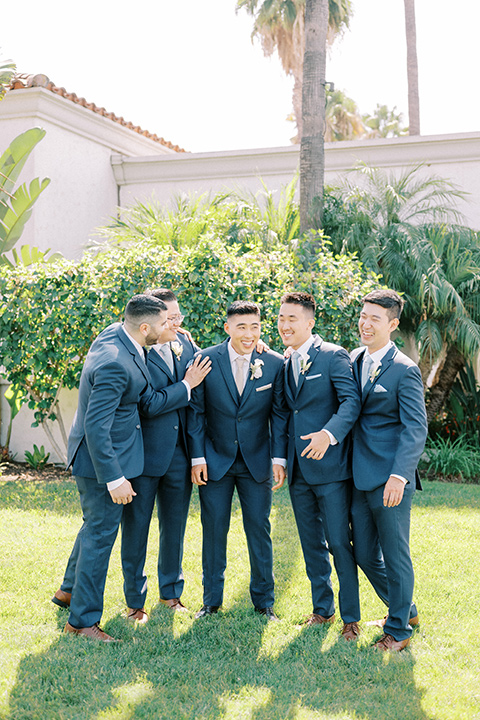  navy and white garden wedding with the groom in a navy suit and the bride in a white ballgown – groomsmen 