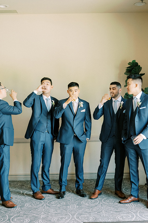  navy and white garden wedding with the groom in a navy suit and the bride in a white ballgown – groomsmen